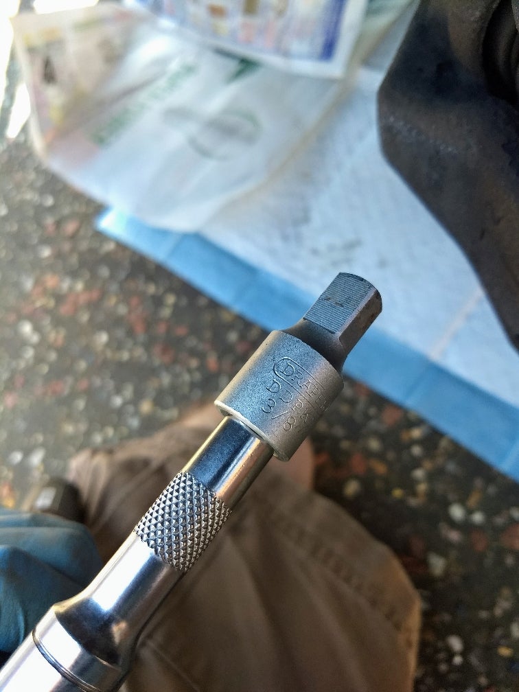 Set up spill control under the drain plug
